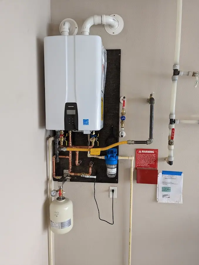 Professional plumber installing copper piping in a Somers home